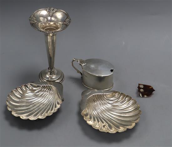 Two silver butter shells, mustard, vase and paper clip.